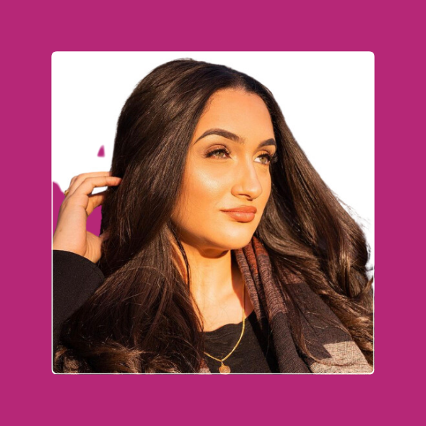 Cynthia, career coaching for internal promotion client, smiling headshot with a patterned scarf on a magenta background